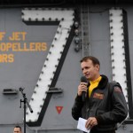 191115-N-IW125-1033 PACIFIC OCEAN (Nov. 14, 2019) Capt. Brett Crozier, commanding officer of the aircraft carrier USS Theodore Roosevelt (CVN 71), addresses the crew during an all-hands call on the ship’s flight deck. Theodore Roosevelt is conducting routine operations in the Eastern Pacific Ocean. (U.S. Navy photo by Mass Communication Specialist 3rd Class Nicholas Huynh)