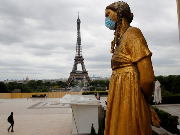 A statue wears a mask along Trocadero square close to the Eiffel Tower in Paris, Monday, May 4, 2020. France continues to be under an extended stay-at-home order until May 11 in an attempt to slow the spread of the COVID-19 pandemic. (AP Photo/Christophe Ena)