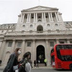 Pedestrians wearing face masks walk past the Bank of England in London, Wednesday, March 11, 2020. Britain's Chancellor of the Exchequer Rishi Sunak will announce the first budget since Britain left the European Union. (AP Photo/Matt Dunham)