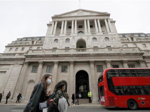 Pedestrians wearing face masks walk past the Bank of England in London, Wednesday, March 11, 2020. Britain's Chancellor of the Exchequer Rishi Sunak will announce the first budget since Britain left the European Union. (AP Photo/Matt Dunham)