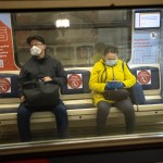 People wearing face masks and gloves to protect against coronavirus, observe social distancing guidelines as they ride a carriage in the subway on the escalator in Moscow, Russia, Wednesday, May 13, 2020. Wearing face masks and latex gloves is mandatory for people using Moscow's public transport. President Vladimir Putin declared an end to a partial economic shutdown across Russia due to the coronavirus pandemic, but he said that many restrictions will remain in place. (AP Photo/Alexander Zemlianichenko)