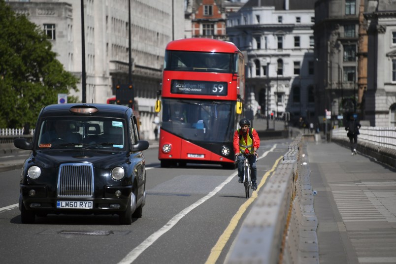 A cyclist rides his bike along Waterloo Bridge, in London, Monday, May 18, 2020. Large areas of London are to be closed to cars and vans to allow people to walk and cycle safely as the coronavirus lockdown is eased, including Waterloo Bridge and London Bridge. (AP Photo/Alberto Pezzali)