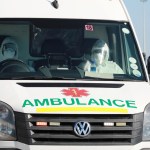 In this photo taken Tuesday, May 19, 2020, paramedics in protective gear drive in an ambulance in Khayelitsha in Cape Town South Africa,  With dramatically increased community transmission, Cape Town has become the center of the COVID-19 outbreak in South Africa and the entire continent. (AP Photo/Nardus Engelbrecht)