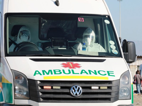 In this photo taken Tuesday, May 19, 2020, paramedics in protective gear drive in an ambulance in Khayelitsha in Cape Town South Africa,  With dramatically increased community transmission, Cape Town has become the center of the COVID-19 outbreak in South Africa and the entire continent. (AP Photo/Nardus Engelbrecht)