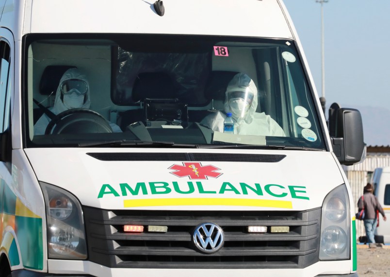 In this photo taken Tuesday, May 19, 2020, paramedics in protective gear drive in an ambulance in Khayelitsha in Cape Town South Africa,  With dramatically increased community transmission, Cape Town has become the center of the COVID-19 outbreak in South Africa and the entire continent. (AP Photo/Nardus Engelbrecht)