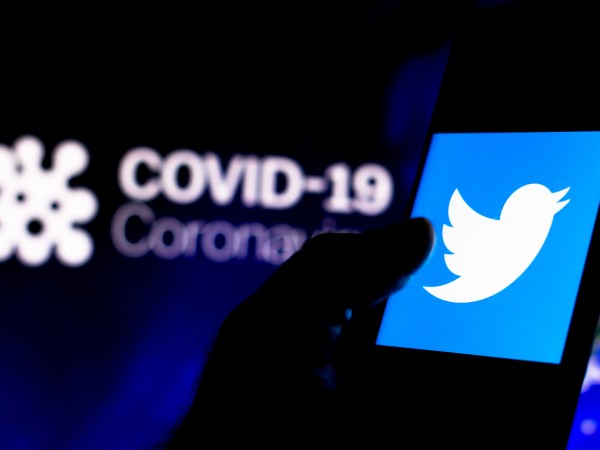BRAZIL - 2020/04/08: In this photo illustration the Twitter logo seen displayed on a smartphone with a computer model of the COVID-19 coronavirus in the background. (Photo Illustration by Rafael Henrique/SOPA Images/LightRocket via Getty Images)