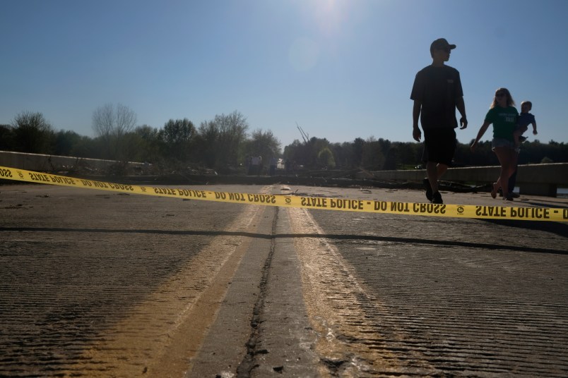 Edenville, MI - MAY 20: Edenville residents explore what remains of the West Curtis Road  bridge which was swept away following extreme flooding throughout central Michigan on May 20, 2020. Tuesday night into Wednesday morning saw record flooding as two dams in Sanford and Eden were breached. (Photo by Matthew Hatcher/Getty Images)