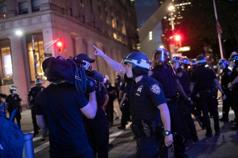 A police officer shouts at Associated Press video journalist Robert Bumsted ordering him to go home despite journalists being exempt from the imposed curfew as he films arrests being made on Tuesday, June 2, 2020, in New York. (AP Photo/Wong Maye-E)