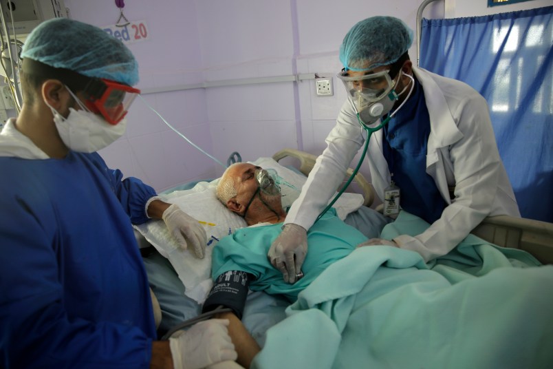 Medical workers attend a patient in an intensive care unit at a hospital for the coronavirus disease COVID-19 in Sanaa, Yemen, Sunday, Jun. 14, 2020. (AP Photo/Hani Mohammed)