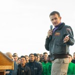 191215-N-KB540-3088 PACIFIC OCEAN (Dec. 19, 2019) Capt. Brett Crozier, commanding officer of the aircraft carrier USS Theodore Roosevelt (CVN 71), gives remarks during an all-hands call on the ship’s flight deck Dec. 15, 2019. Theodore Roosevelt is underway conducting routine training in the Eastern Pacific Ocean. (U.S. Navy photo by Mass Communication Specialist Seaman Alexander Williams)