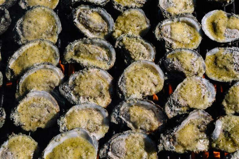 New Orleans, LA - April 30, 2020 - Charbroiled oysters are prepared in the parking lot of St. Dominic Church by staff from Drago's Seafood Restaurant.Many local restaurants have resorted to curbside service and orders to-go during the stay-at-home order to prevent the spread of the coronavirus. (William Widmer for The Washington Post)