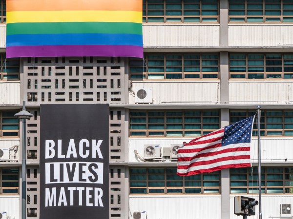 SEOUL, SOUTH KOREA - 2020/06/14: A Black Lives Matter banner, a United States national flag and a rainbow flag are hung on the facade of the US embassy building in Seoul.A Black Lives Matter (BLM) banner is hung on the facade of the US Embassy building in downtown Seoul in solidarity with the BLM protesters who are demanding for a positive change. (Photo by Simon Shin/SOPA Images/LightRocket via Getty Images)