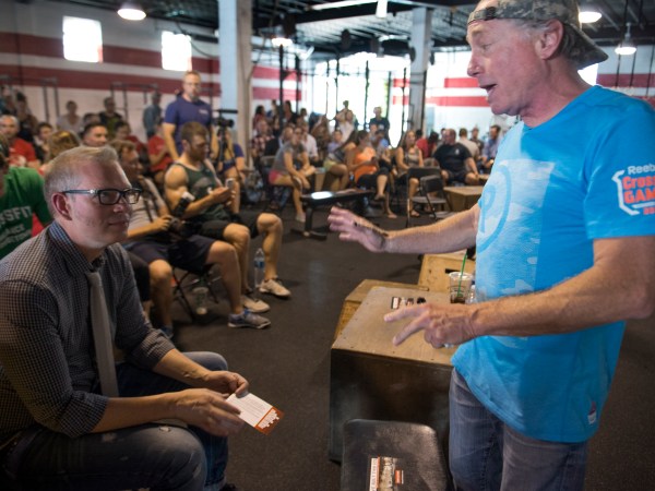 WASHINGTON, DC - JULY 31:    Crossfit Inc. founder and CEO Greg Glassman (R) talks to employees prior to a presentation at the half street location in Washington, DC on July 31, 2015.  CrossFit is waging a war against new DC rules to regulate personal trainers, saying D.C. is a pawn in a commercial fight over personal fitness.  The city council is proposing licensure and regulation of personal trainers.  There is a fee involved.  If the law should pass, DC would be the first municipality in the nation to do so.  Crossfit Inc. officials are fighting the proposed law and say that they are trying to legislate something that they do not understand.   (Photo by Linda Davidson / The Washington Post)
