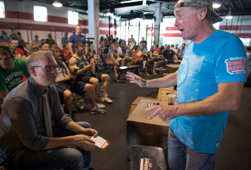 WASHINGTON, DC - JULY 31:    Crossfit Inc. founder and CEO Greg Glassman (R) talks to employees prior to a presentation at the half street location in Washington, DC on July 31, 2015.  CrossFit is waging a war against new DC rules to regulate personal trainers, saying D.C. is a pawn in a commercial fight over personal fitness.  The city council is proposing licensure and regulation of personal trainers.  There is a fee involved.  If the law should pass, DC would be the first municipality in the nation to do so.  Crossfit Inc. officials are fighting the proposed law and say that they are trying to legislate something that they do not understand.   (Photo by Linda Davidson / The Washington Post)