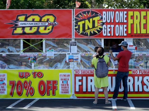 People purchase fireworks on Thursday, July 2, 2020, in Dublin, Calif. (AP Photo/Ben Margot)