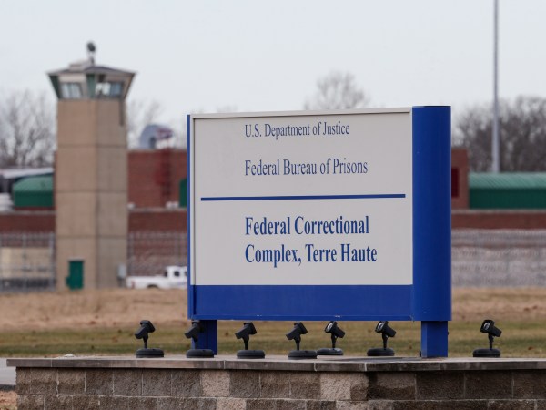 The guard tower flanks the sign at the entrance to the U.S. Penitentiary in Terre Haute, Ind.,  in Terre Haute, Ind., Tuesday, Dec. 10, 2019.  The facility houses a Special Confinement Unit for male federal inmates who have been sentenced to death as well as the federal execution chamber. (AP Photo/Michael Conroy)