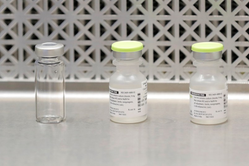 Vials used by pharmacists to prepare syringes used on the first day of a first-stage safety study clinical trial of the potential vaccine for COVID-19, the disease caused by the new coronavirus, rest on a lab table at the Kaiser Permanente Washington Health Research Institute in Seattle on Monday, March 16, 2020. (AP Photo/Ted S. Warren)