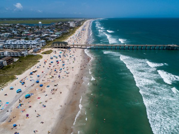 Beachgoers pack Wrightsville Beach Sunday, Aug. 2, 2020 as Tropical Storm Isaias moves along the Southeast Coast.