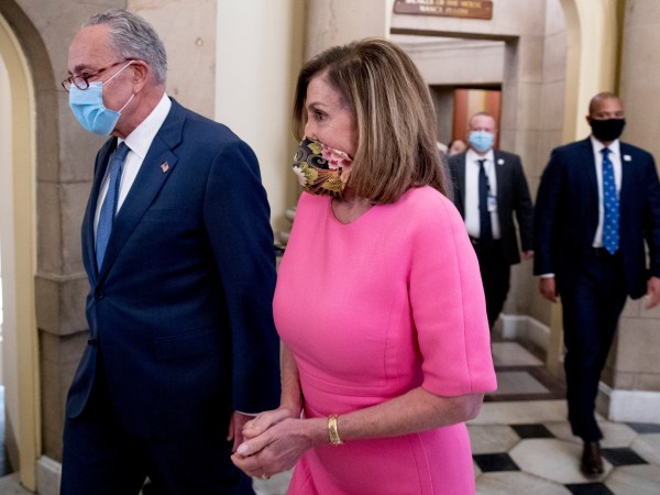 Senate Minority Leader Sen. Chuck Schumer of N.Y., left, and House Speaker Nancy Pelosi of Calif., right, walk out of a meeting with Treasury Secretary Steven Mnuchin and White House Chief of Staff Mark Meadows as they continue to negotiate a coronavirus relief package on Capitol Hill in Washington, Friday, Aug. 7, 2020. (AP Photo/Andrew Harnik)