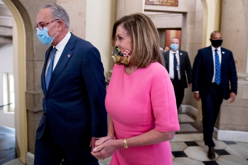 Senate Minority Leader Sen. Chuck Schumer of N.Y., left, and House Speaker Nancy Pelosi of Calif., right, walk out of a meeting with Treasury Secretary Steven Mnuchin and White House Chief of Staff Mark Meadows as they continue to negotiate a coronavirus relief package on Capitol Hill in Washington, Friday, Aug. 7, 2020. (AP Photo/Andrew Harnik)