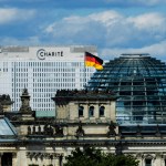 25 August 2020, Berlin: The bed skyscraper of the Berliner Charite can be seen behind the Reichstag building (photographed through a window pane). In the clinic the Russian oppositional Nawalny is treated. Doctors of the Berliner Charite assume that the Kremlin critic was poisoned. Photo: Christoph Soeder/dpa