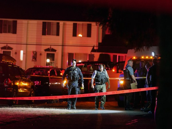 Police officials work at a scene where a man suspected of fatally shooting a supporter of a right-wing group in Portland, Oregon, last week was killed as investigators moved in to arrest him in Lacey, Wash., on Thursday, Sept. 3, 2020. (AP Photo/Ted Warren)