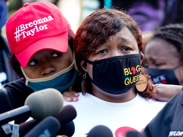Tamika Palmer, the mother of Breonna Taylor, right, listens to a news conference, Friday, Sept. 25, 2020, in Louisville, Ky. Family attorney Ben Crump is calling for the Kentucky attorney general to release the transcripts from the grand jury that decided not to charge any of the officers involved in the Black woman’s death. (AP Photo/Darron Cummings)