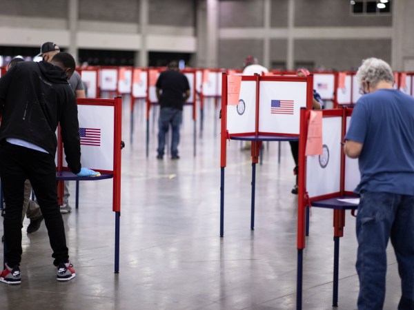 LOUISVILLE, KY - JUNE 23:  A polling worker (left) cleans a voting booth between voters during Tuesday’s primary election on June 23, 2020 in Louisville, Kentucky. The Kentucky Exposition Center is the only polling location for Tuesday’s Kentucky primary in Jefferson County, home to Louisville and 767,000 residents.  (Photo by Brett Carlsen/Getty Images)