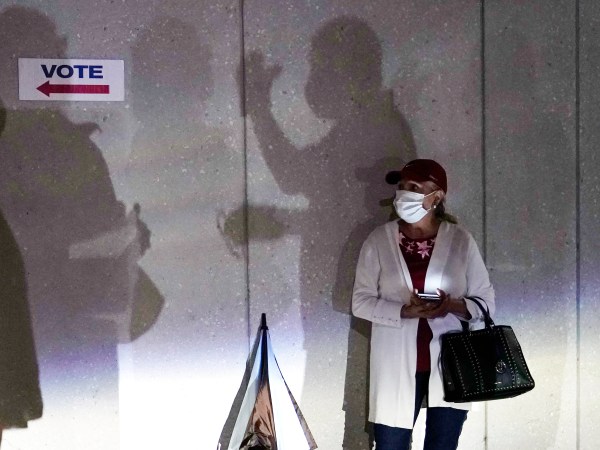 A woman waits to vote, Monday, Oct. 19, 2020, in Miami. Florida begins in-person early voting in much of the state Monday. With its 29 electoral votes, Florida is crucial to both candidates in order to win the White House. (AP Photo/Lynne Sladky)