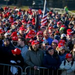 People wait outside the airport before a campaign rally with President Donald Trump Friday, Oct. 30, 2020, in Rochester, Minn. (AP Photo/Bruce Kluckhohn)