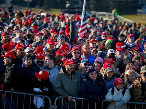 People wait outside the airport before a campaign rally with President Donald Trump Friday, Oct. 30, 2020, in Rochester, Minn. (AP Photo/Bruce Kluckhohn)