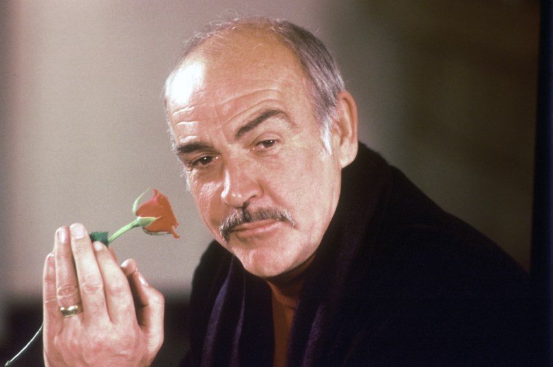 Actor Sean Connery holds a rose in his hand as he talks about his new movie "The Name of the Rose" at a news conference in London, England, Jan. 23, 1987.  (AP Photo/Gerald Penny)