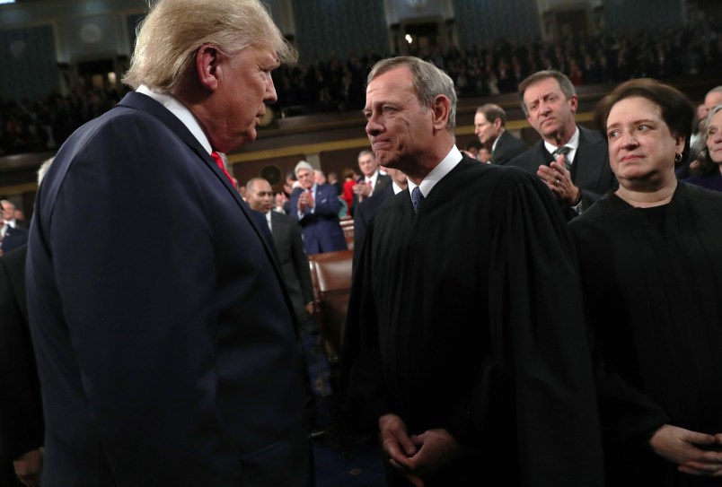 U.S. President Donald Trump talks to  Supreme Court Chief Justice John Roberts while Associate Justice Elena Kagan looks on as the president arrives to U.S. President Donald Trump delivers his State of the Union address to a joint session of the U.S. Congress in the House Chamber of the U.S. Capitol in Washington, U.S., February 3, 2020. REUTERS/Leah Millis/POOL