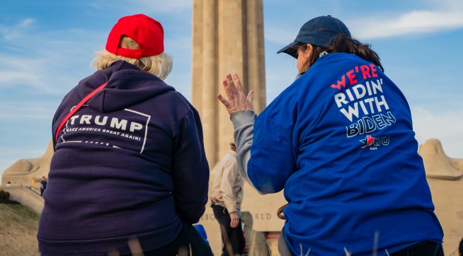 KANSAS CITY, MO - MARCH 07: A President Donald Trump and a former Vice President Joe Biden supporter converse before the Joe Biden Campaign Rally at the National World War I Museum and Memorial on March 7, 2020 in Kansas City, Missouri. (Photo by Kyle Rivas/Getty Images)