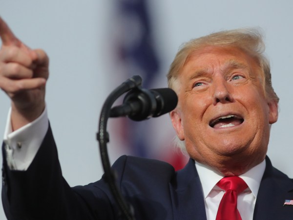 President Donald Trump responds to cheering supporters as he arrives for a campaign rally at Orlando-Sanford International Airport in Sanford, Florida on Monday, Oct. 12, 2020.  (Joe Burbank/Orlando Sentinel/TNS)