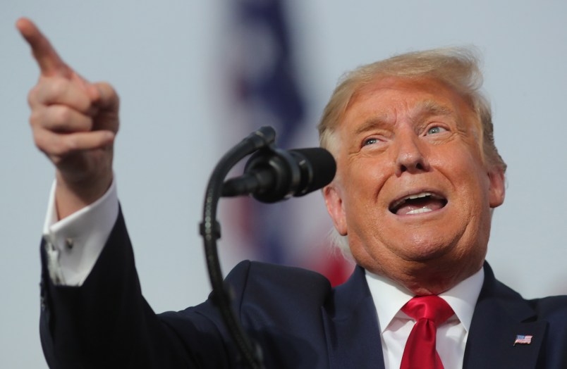 President Donald Trump responds to cheering supporters as he arrives for a campaign rally at Orlando-Sanford International Airport in Sanford, Florida on Monday, Oct. 12, 2020.  (Joe Burbank/Orlando Sentinel/TNS)