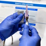 Registered Nurse Kath Olmstead prepares  a blinded study experimental vaccine for COVID-19 developed by the National Institutes of Health and Moderna Inc. at the United Health Services facility, Monday, July 27, 2020, in Binghamton, N.Y. (AP Photo/Hans Pennink