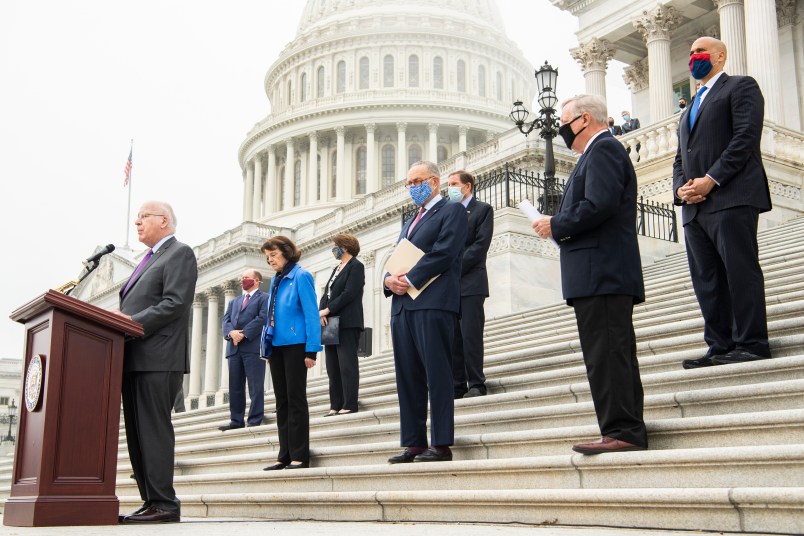 UNITED STATES - OCTOBER 22: From left, Sens. Patrick Leahy, D-Vt., Chris Coons, D-Del., Senate Judiciary Committee ranking member Dianne Feinstein, D-Calif., Sen. Amy Klobuchar, D-Minn., Senate Minority Leader Charles Schumer, D-N.Y., Sens. Richard Blumenthal, D-Conn., Richard Durbin, D-Ill., and Cory Booker, D-N.J., attend a news conference on the Senate steps of the Capitol with Democratic members of the Senate Judiciary Committee after they boycotted the markup of Supreme Court justice nominee Judge Amy Coney Barrett, on Thursday, October 22, 2020. (Photo By Tom Williams/CQ Roll Call)