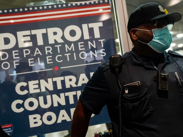 DETROIT, MI - NOVEMBER 04: A police officer stands at the entrance to the Detroit Department of Elections Central Counting Board of Voting absentee ballot counting center at TCF Center, Wednesday, Nov. 4, 2020 in Detroit, MI. With the surge in vote by mail/absentee ballots, analysts cautioned it could take days to count all the ballots, leading some states to initially look like victories for President Trump only to later shift towards democratic Presidential candidate Joe Biden.