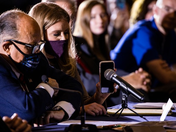 GETTYSBURG, PA - NOVEMBER 25: Jenna Ellis, a member of President Donald Trumps legal team, holds up a cell phone to the microphone so President Trump can speak during a Pennsylvania Senate Majority Policy Committee public hearing Wednesday at the Wyndham Gettysburg hotel to discuss 2020 election issues and irregularities on November 25, 2020 in Gettysburg, Pennsylvania. Giuliani is continuing his push to over turn election results in the courts. (Photo by Samuel Corum/Getty Images) *** Local Caption *** Jenna Ellis; Rudy Giuliani