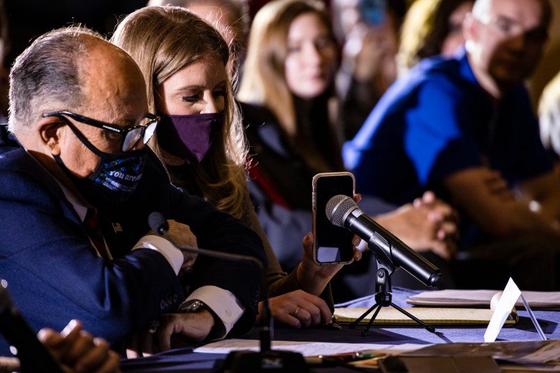 GETTYSBURG, PA - NOVEMBER 25: Jenna Ellis, a member of President Donald Trumps legal team, holds up a cell phone to the microphone so President Trump can speak during a Pennsylvania Senate Majority Policy Committee public hearing Wednesday at the Wyndham Gettysburg hotel to discuss 2020 election issues and irregularities on November 25, 2020 in Gettysburg, Pennsylvania. Giuliani is continuing his push to over turn election results in the courts. (Photo by Samuel Corum/Getty Images) *** Local Caption *** Jenna Ellis; Rudy Giuliani