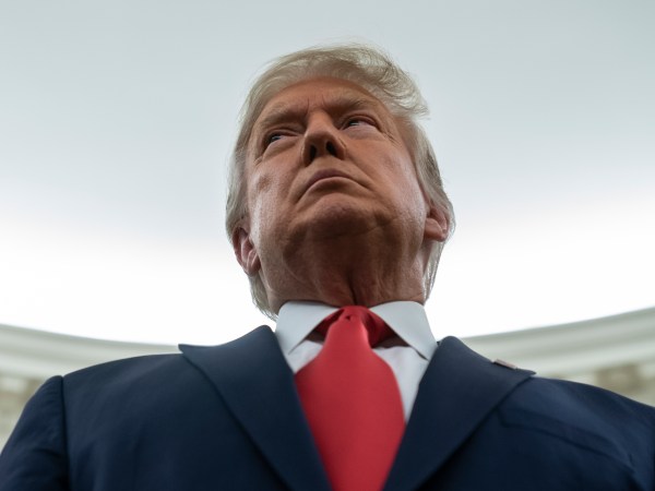 President Donald Trump listens during a ceremony to present the Presidential Medal of Freedom to former football coach Lou Holtz, in the Oval Office of the White House, Thursday, Dec. 3, 2020, in Washington. (AP Photo/Evan Vucci)
