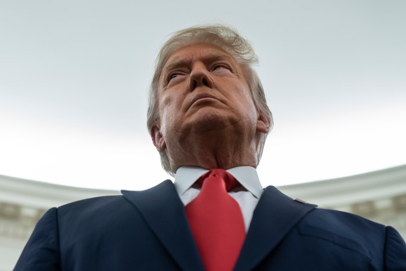 President Donald Trump listens during a ceremony to present the Presidential Medal of Freedom to former football coach Lou Holtz, in the Oval Office of the White House, Thursday, Dec. 3, 2020, in Washington. (AP Photo/Evan Vucci)