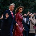 President Donald Trump and first lady Melania Trump walk on the South Lawn of the White House in Washington, Saturday, Dec. 5, 2020, before boarding Marine One for a short trip to Andrews Air Force Base, Md. Trump is en route to Georgia for a rally for U.S. Senate candidates David Perdue and Kelly Loeffler. (AP Photo/Patrick Semansky)