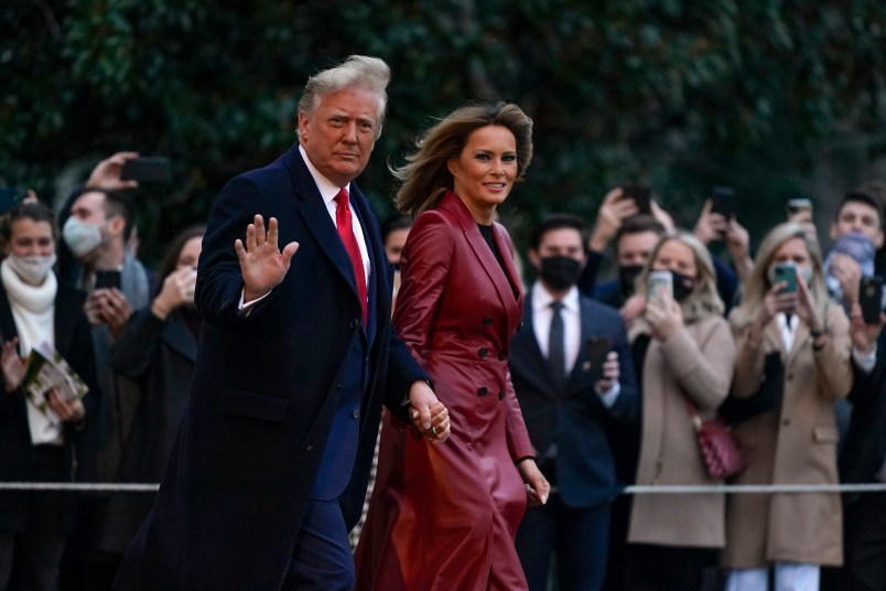 President Donald Trump and first lady Melania Trump walk on the South Lawn of the White House in Washington, Saturday, Dec. 5, 2020, before boarding Marine One for a short trip to Andrews Air Force Base, Md. Trump is en route to Georgia for a rally for U.S. Senate candidates David Perdue and Kelly Loeffler. (AP Photo/Patrick Semansky)