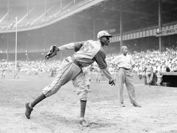 FILE - In this Aug. 2, 1942, file photo, Kansas City Monarchs pitcher Leroy Satchel Paige warms up at New York's Yankee Stadium before a Negro League game between the Monarchs and the New York Cuban Stars.  Major League Baseball has reclassified the Negro Leagues as a major league and will count the statistics and records of its 3,400 players as part of its history. The league said Wednesday, Dec. 16, 2020, it was “correcting a longtime oversight in the game's history” by elevating the Negro Leagues on the centennial of its founding.  (AP Photo/Matty Zimmerman, File)