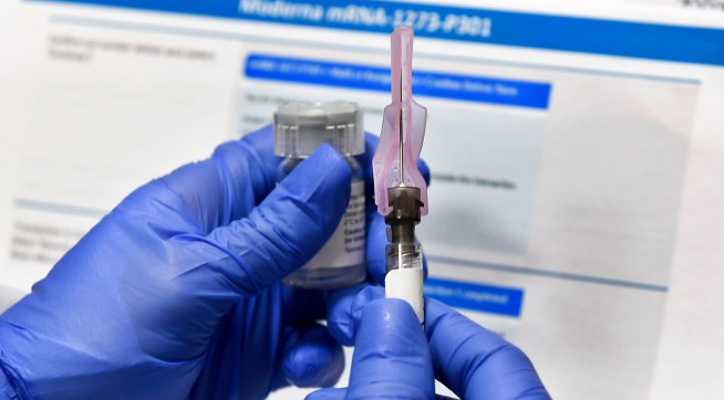 Nurse Kathe Olmstead prepares a shot as the world's biggest study of a possible COVID-19 vaccine, developed by the National Institutes of Health and Moderna Inc., gets underway Monday, July 27, 2020, in Binghamton, N.Y. (AP Photo/Hans Pennink)