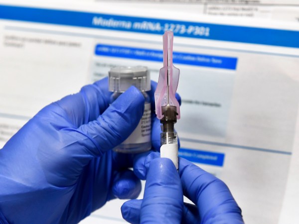 Nurse Kathe Olmstead prepares a shot as the world's biggest study of a possible COVID-19 vaccine, developed by the National Institutes of Health and Moderna Inc., gets underway Monday, July 27, 2020, in Binghamton, N.Y. (AP Photo/Hans Pennink)
