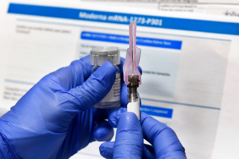 Nurse Kathe Olmstead prepares a shot as the world's biggest study of a possible COVID-19 vaccine, developed by the National Institutes of Health and Moderna Inc., gets underway Monday, July 27, 2020, in Binghamton, N.Y. (AP Photo/Hans Pennink)