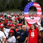 WILKES BARRE, PA - AUGUST 02: David Reinert holds up a large "Q" sign while waiting in line on August 2, 2018 at the Mohegan Sun Arena at Casey Plaza in Wilkes Barre, Pennsylvania to see President Donald J. Trump at his rally. "Q" is a conspiracy theory group that has been seen at recent rallies. (Photo by Rick Loomis/Getty Images)